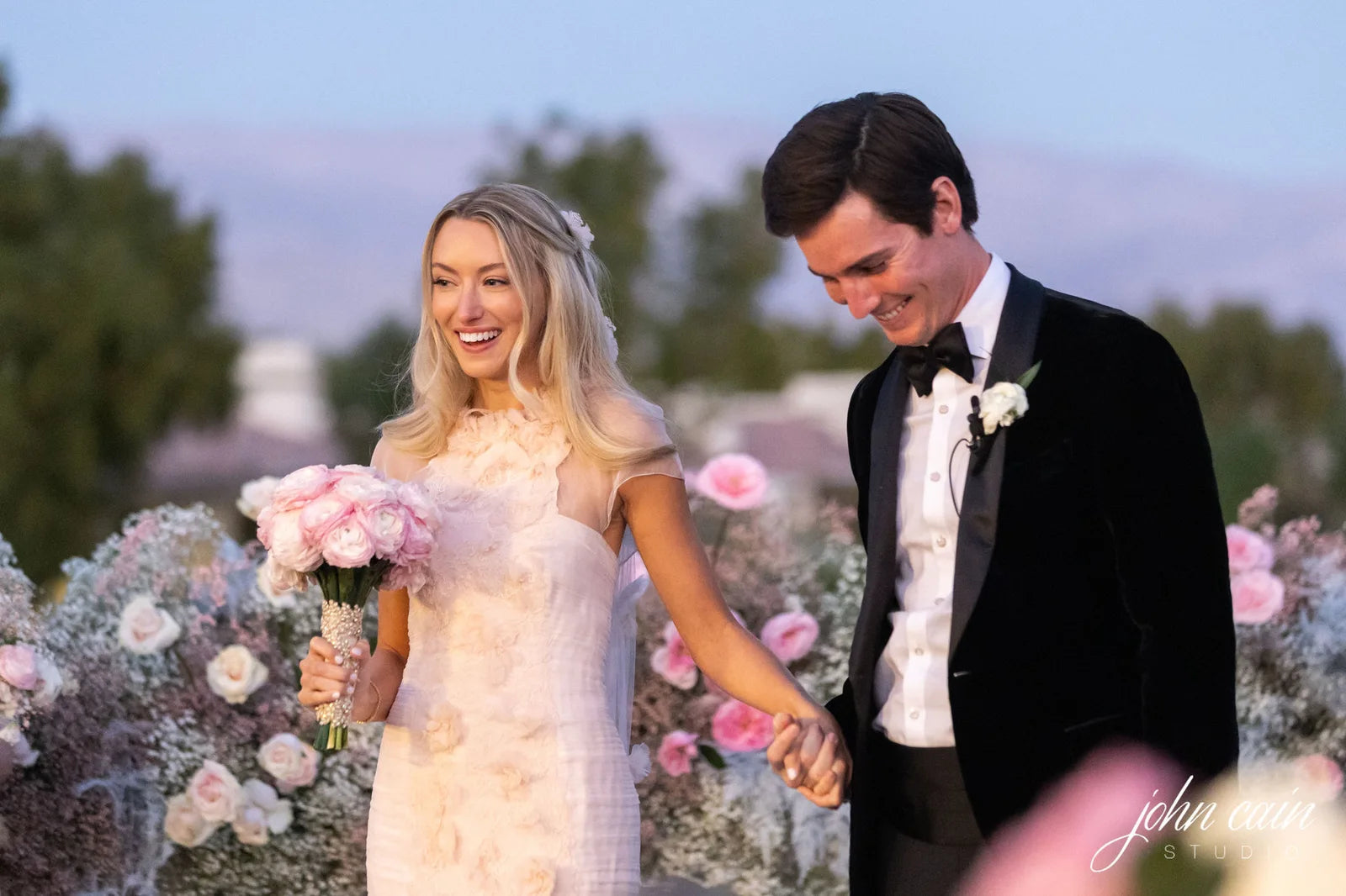 A wedding couple with pink flowers