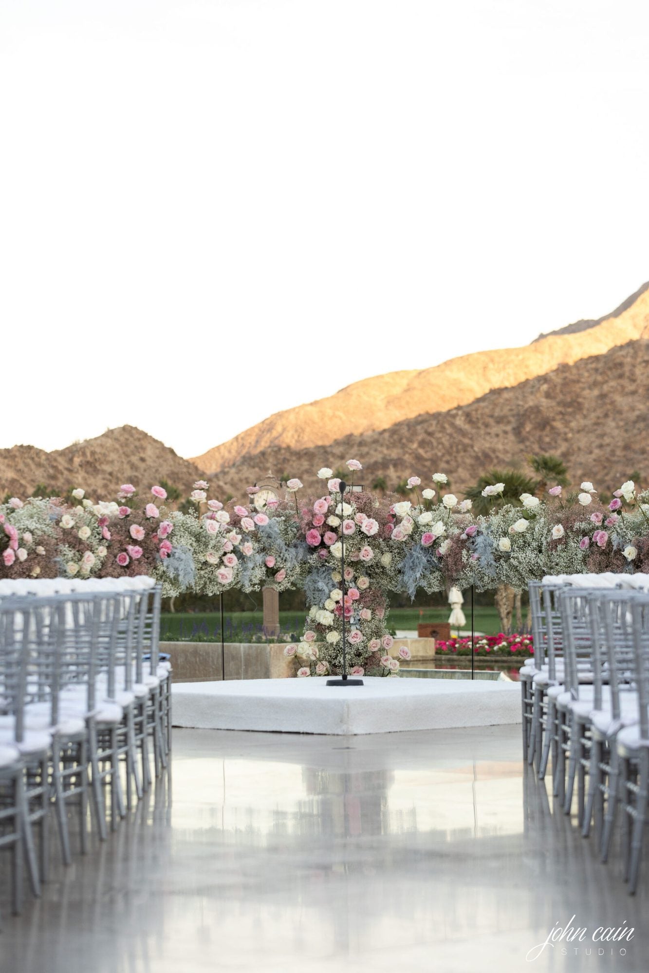 White floral installation lining an event aisle