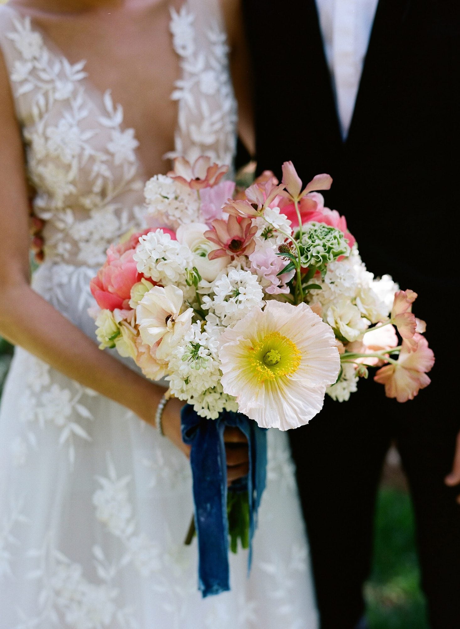 A couple beneath a floral installation