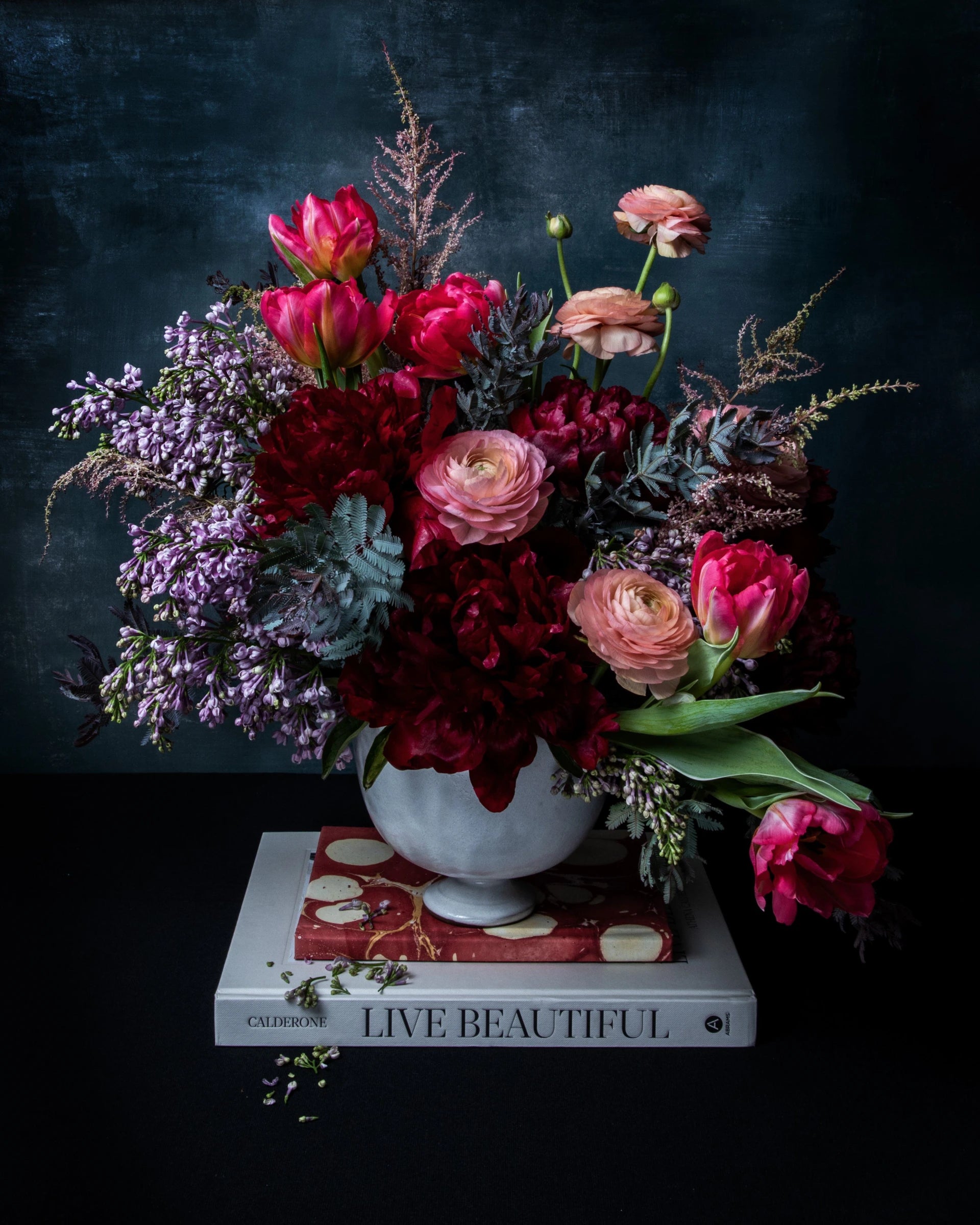 Jewel-toned arrangement on a stack of books